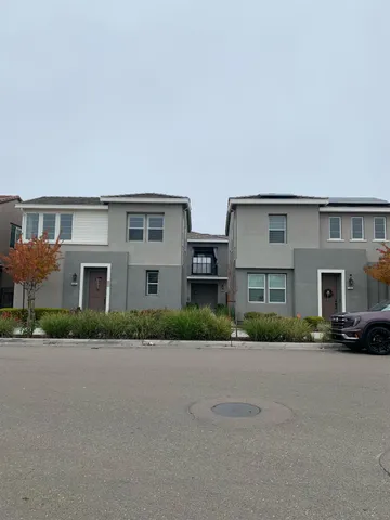 a front view of residential houses with yard