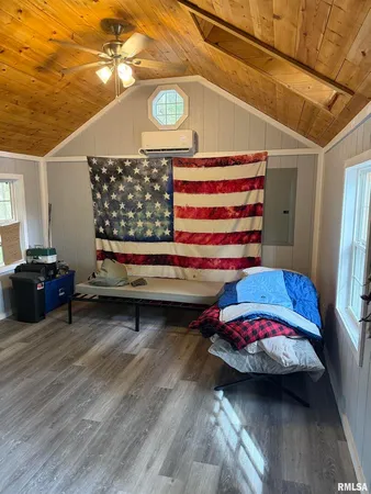 a bedroom with furniture and a window