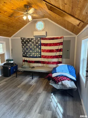 a bedroom with furniture and a window