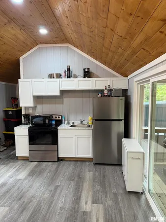 a kitchen with a white stove top oven and refrigerator