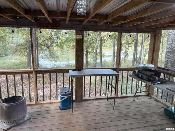 a view of a chairs and table on the wooden deck