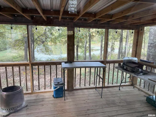a view of a chairs and table on the wooden deck