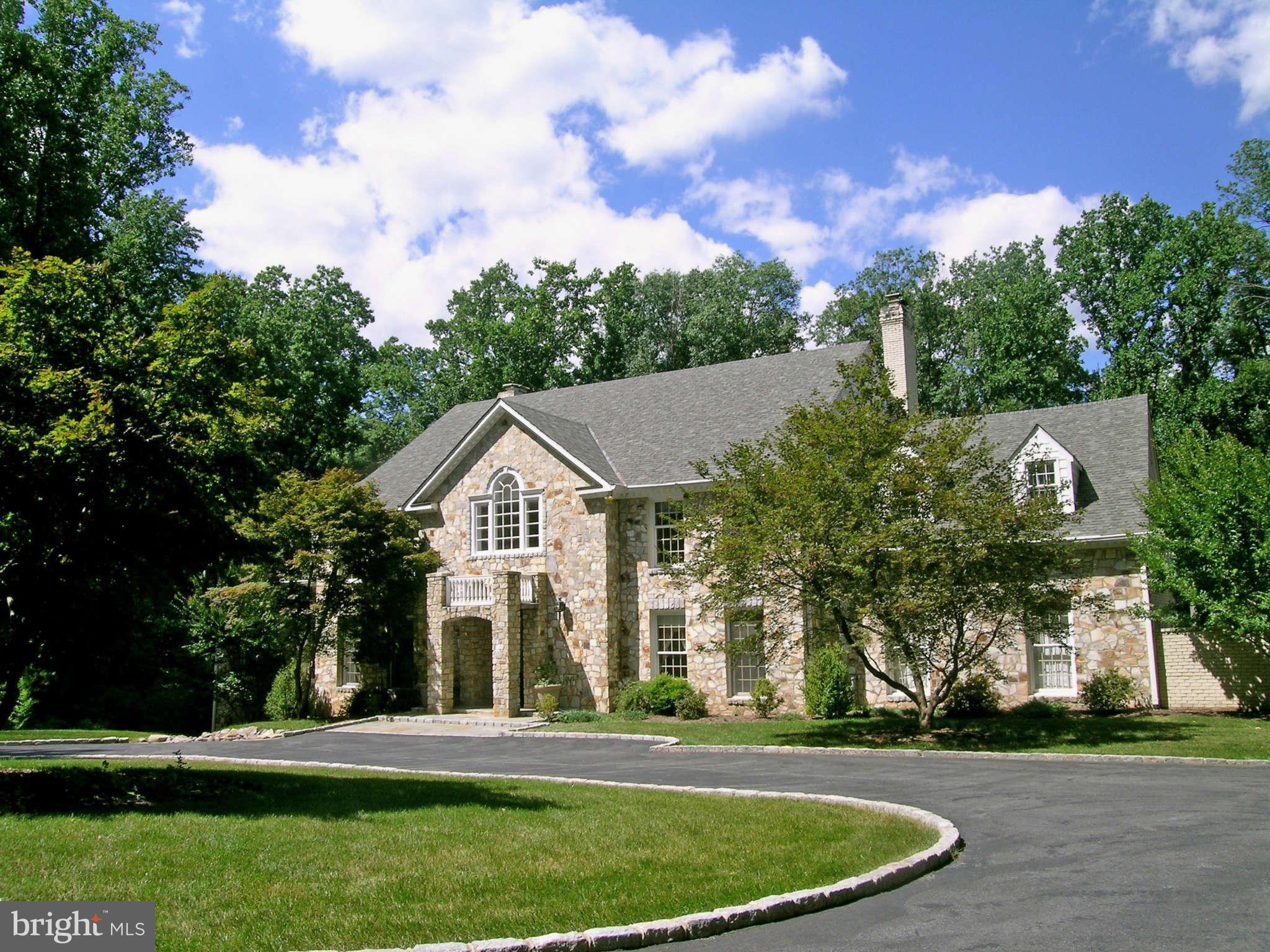 7570 Potomac Fall Road McLean, VA 22102 - Photo 1 of 20 a view of a white house with a big yard and large trees