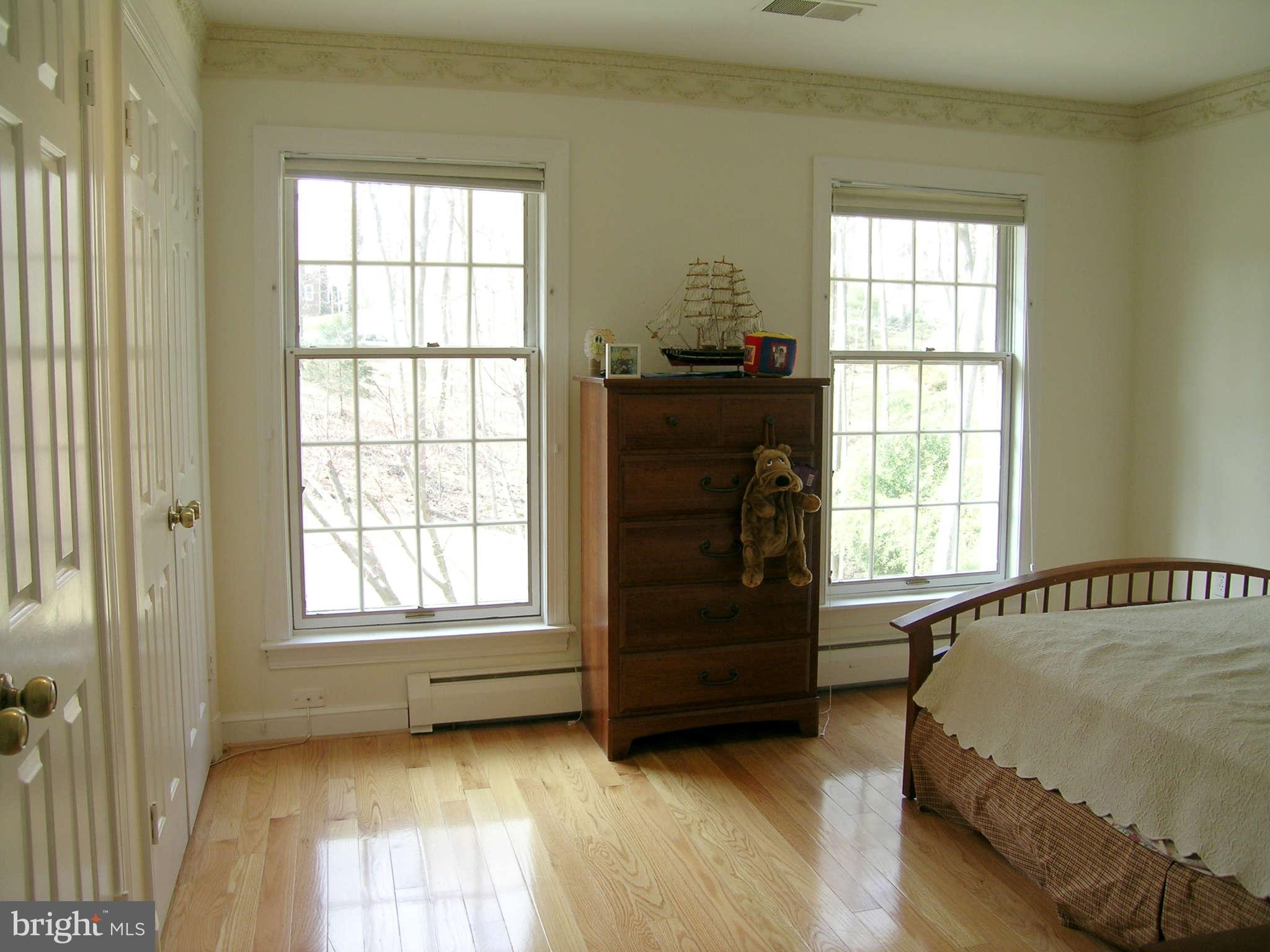 7570 Potomac Fall Road McLean, VA 22102 - Photo 13 of 20 a spacious bedroom with a bed and a window