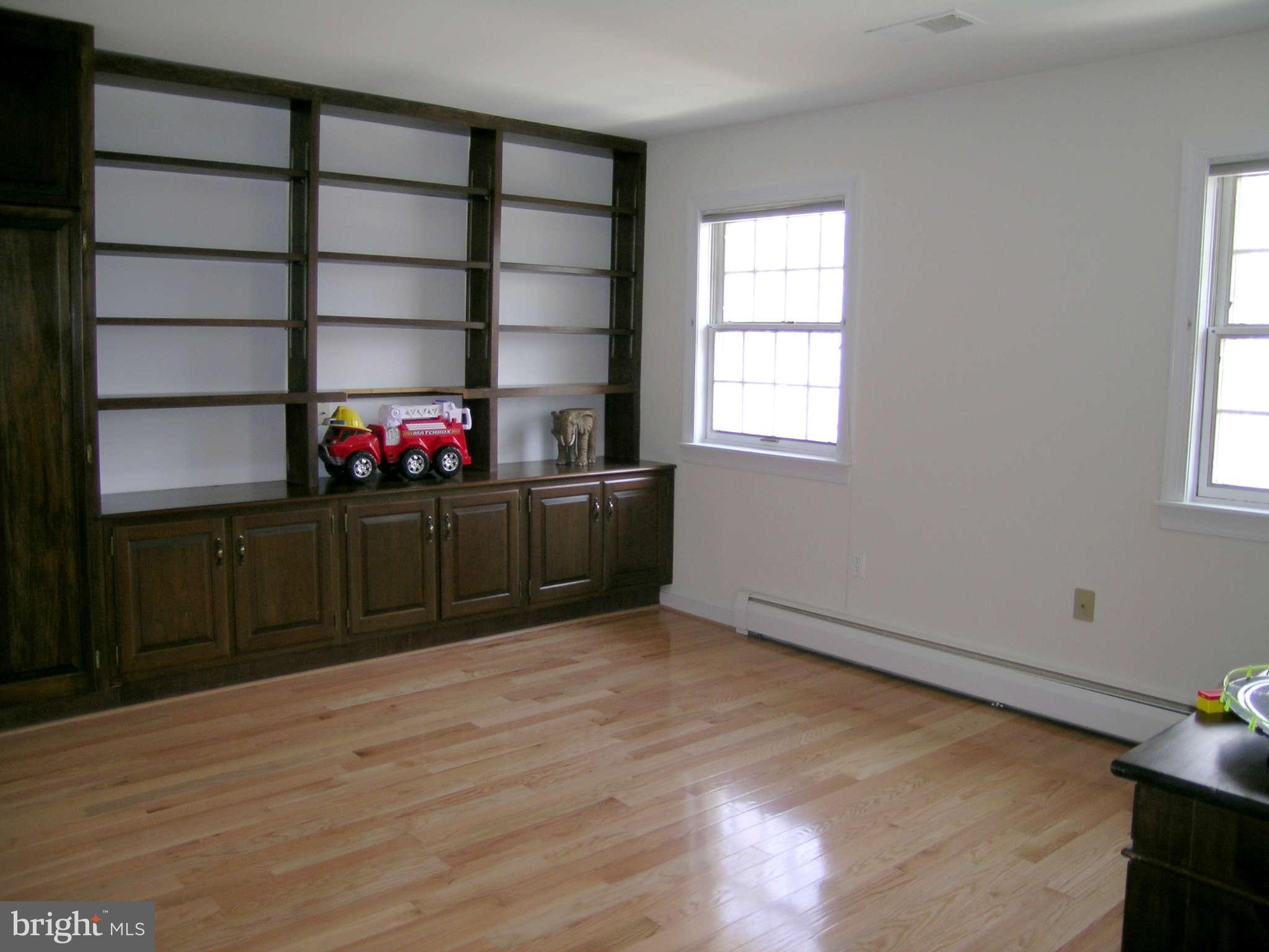 7570 Potomac Fall Road McLean, VA 22102 - Photo 14 of 20 an empty room with wooden floor and windows