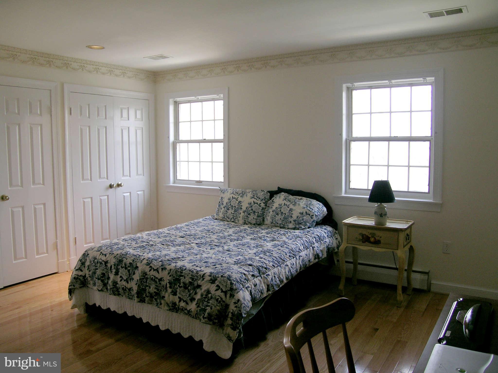 7570 Potomac Fall Road McLean, VA 22102 - Photo 15 of 20 a bedroom with a bed table chair and a window