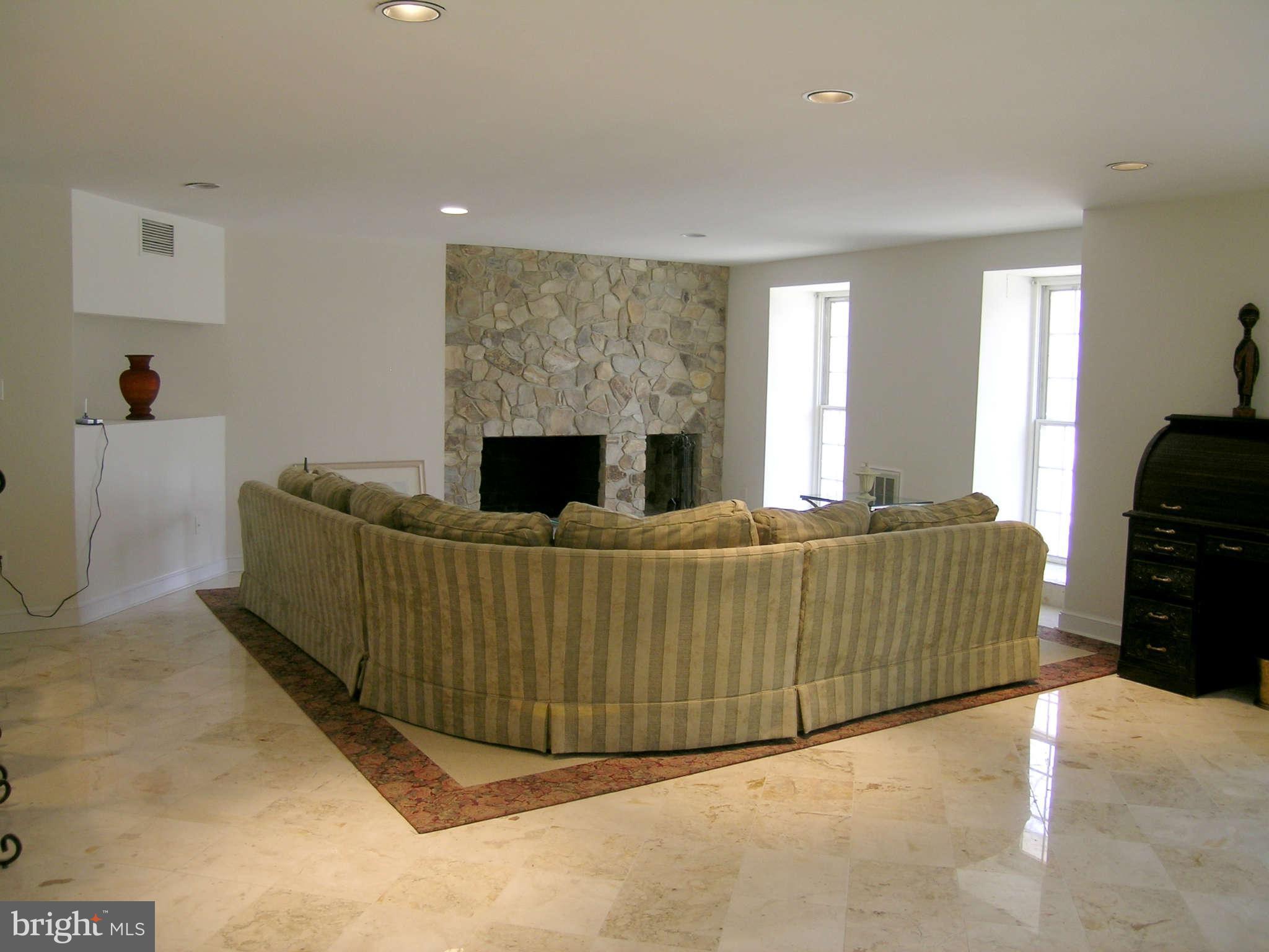 7570 Potomac Fall Road McLean, VA 22102 - Photo 16 of 20 a living room with furniture and a flat screen tv