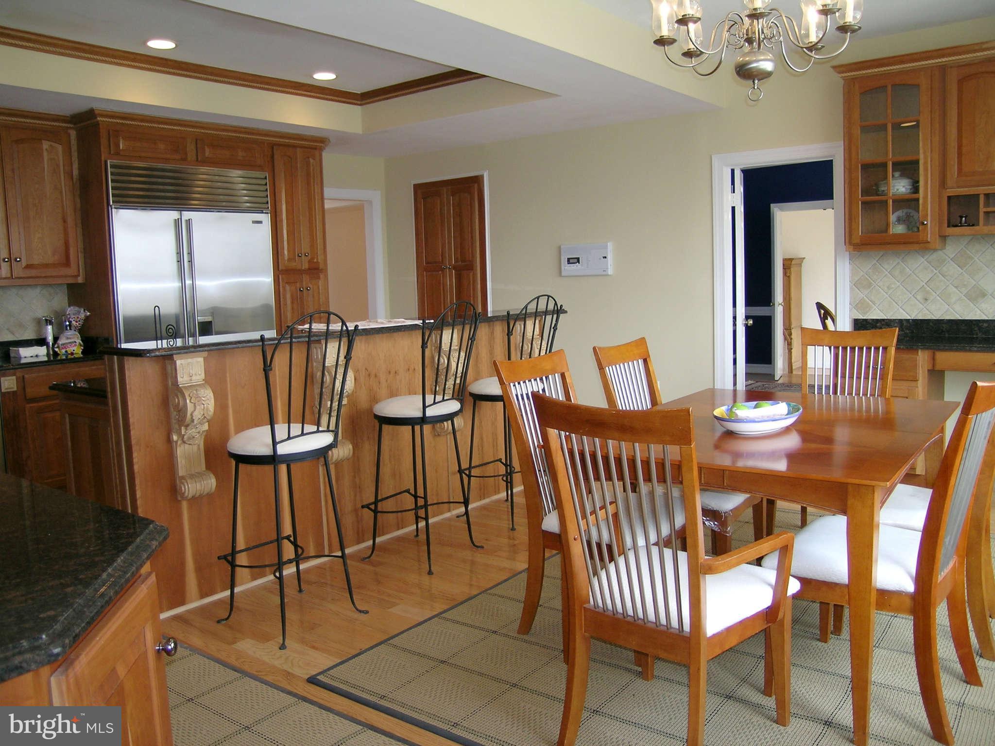7570 Potomac Fall Road McLean, VA 22102 - Photo 6 of 20 a view of a dining room with furniture and chandelier