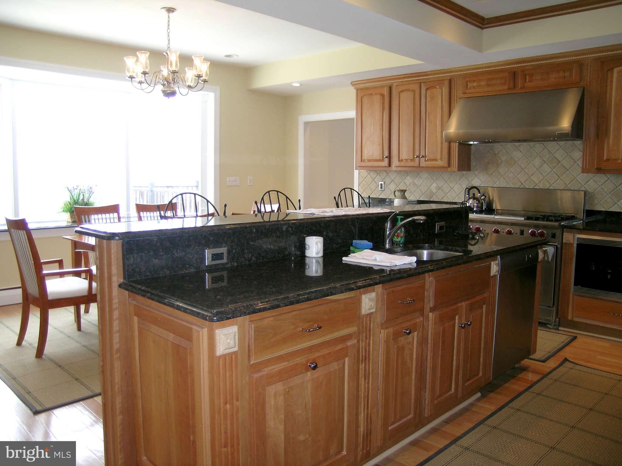 7570 Potomac Fall Road McLean, VA 22102 - Photo 7 of 20 a kitchen with stainless steel appliances granite countertop a sink a stove and a cabinets