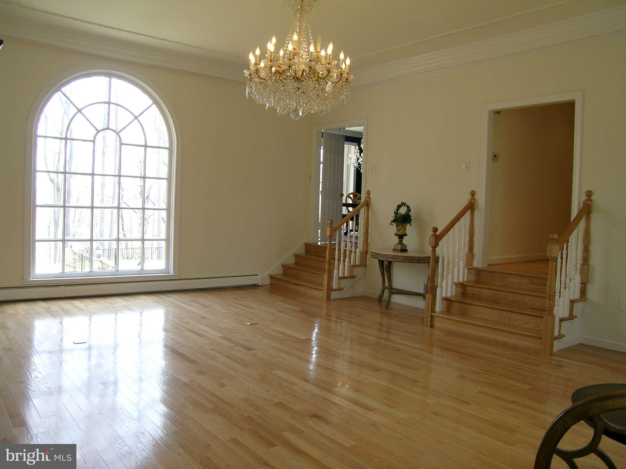 7570 Potomac Fall Road McLean, VA 22102 - Photo 9 of 20 a view of an empty room with wooden floor and a window