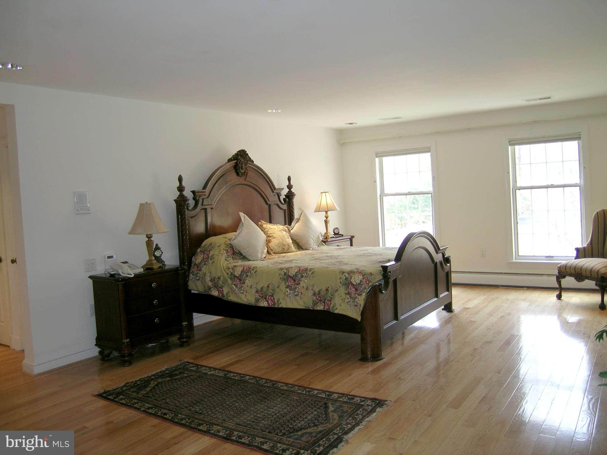 7570 Potomac Fall Road McLean, VA 22102 - Photo 10 of 20 a bedroom with a bed and wooden floor