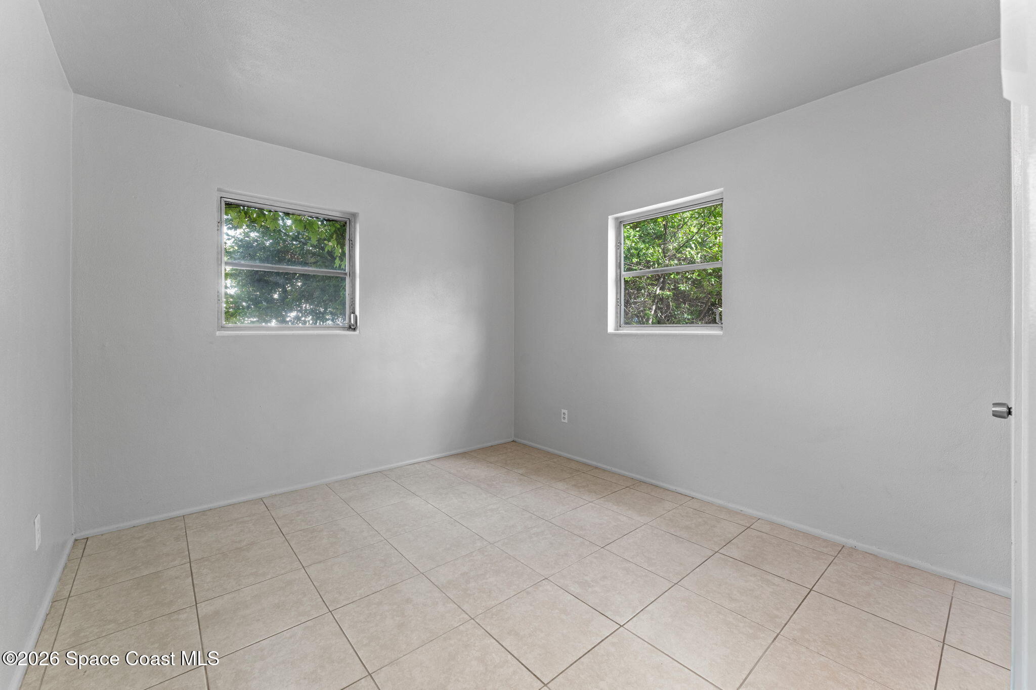 1042 Azalea Lane Cocoa, FL 32922 - Photo 19 of 26 an empty room with windows
