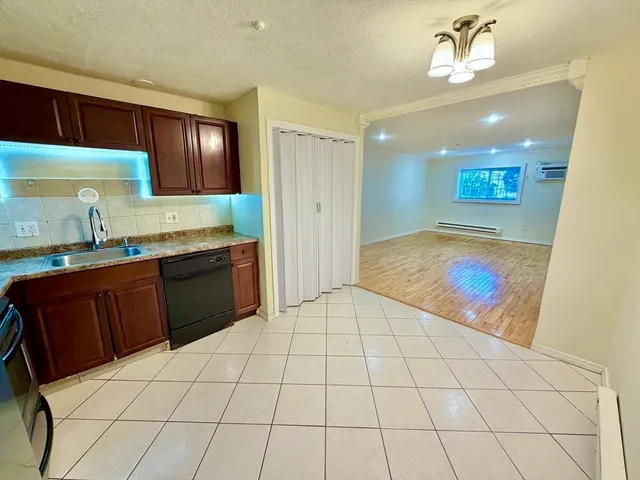 a kitchen with a sink a stove and cabinets