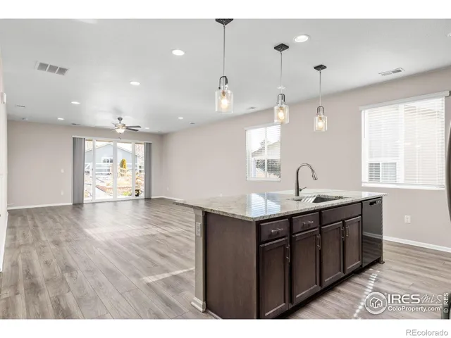 a view of a kitchen with a sink and window
