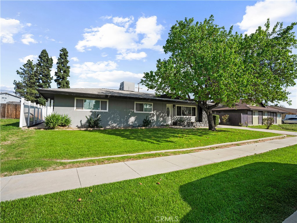 1455 North Alice Avenue Rialto, CA 92376 - Photo 1 of 23 a front view of a house with a yard table and chairs