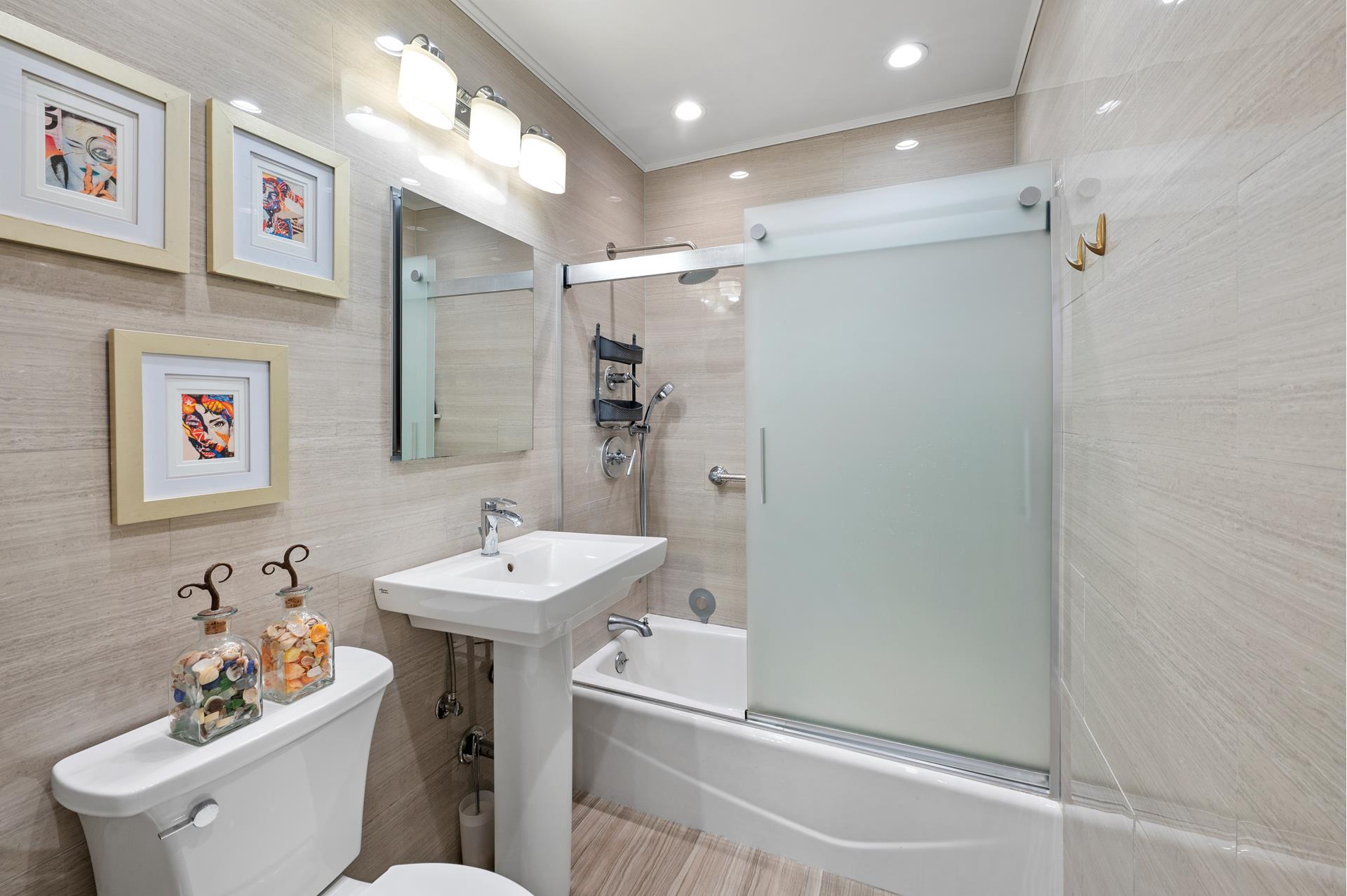 622 Washington Street, Unit GB Manhattan, NY 10014 - Photo 5 of 8 a bathroom with a sink mirror toilet and vanity