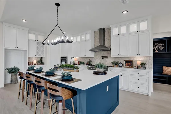 a kitchen with a sink a stove and chairs