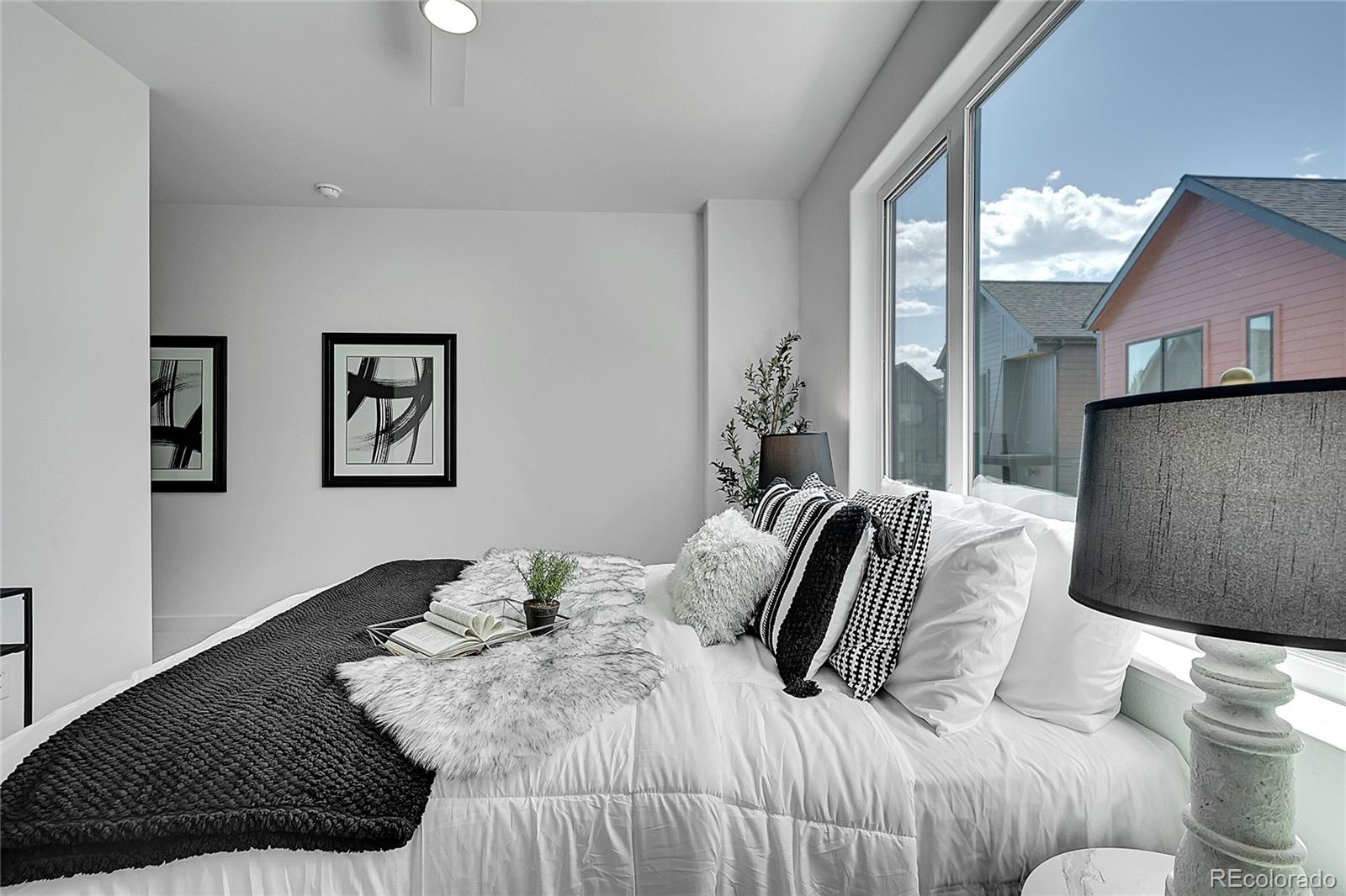 765 East County Line Road Erie, CO 80516 - Photo 19 of 28 a bedroom with a bed and a couch