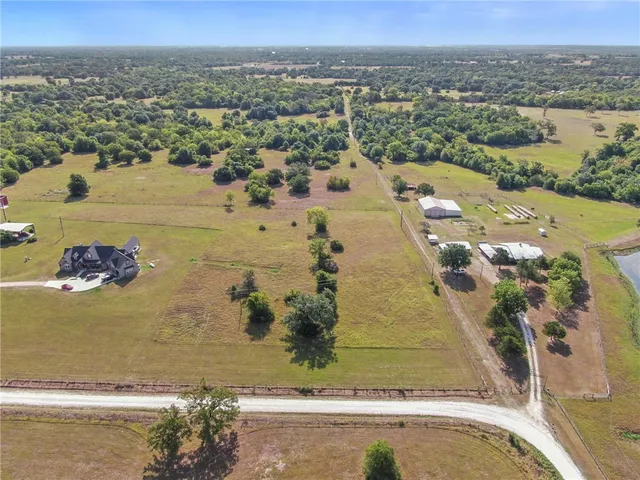 an aerial view of a residential houses with outdoor space