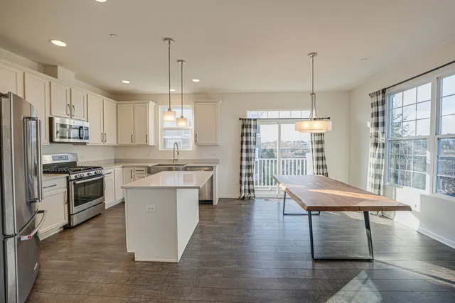 a kitchen with sink cabinets and wooden floor