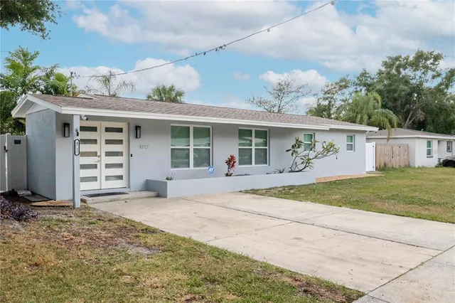a view of a house with a yard and garage