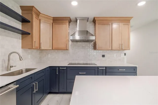 a kitchen with stainless steel appliances granite countertop a sink stove and cabinets