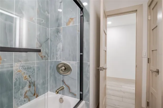 a bathroom with a bathtub and a shower