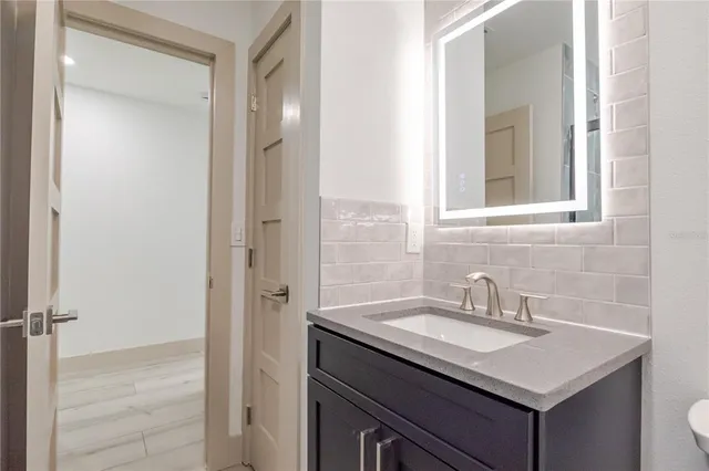 a bathroom with a sink vanity and a mirror