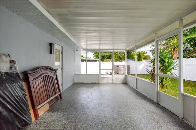 a view of a porch with furniture and garden