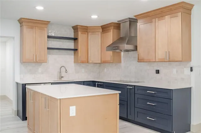a kitchen with stainless steel appliances granite countertop a sink a stove and a refrigerator with wooden cabinets