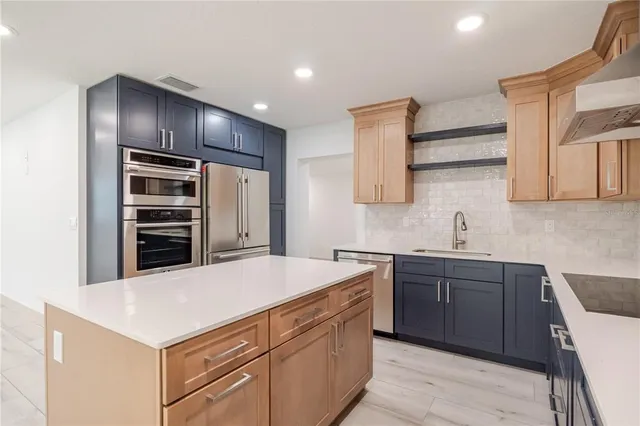a kitchen with a stove a sink and a refrigerator