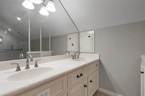 a bathroom with a double vanity sink and a mirror