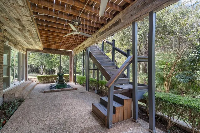 a view of a patio with a table chairs and wooden fence