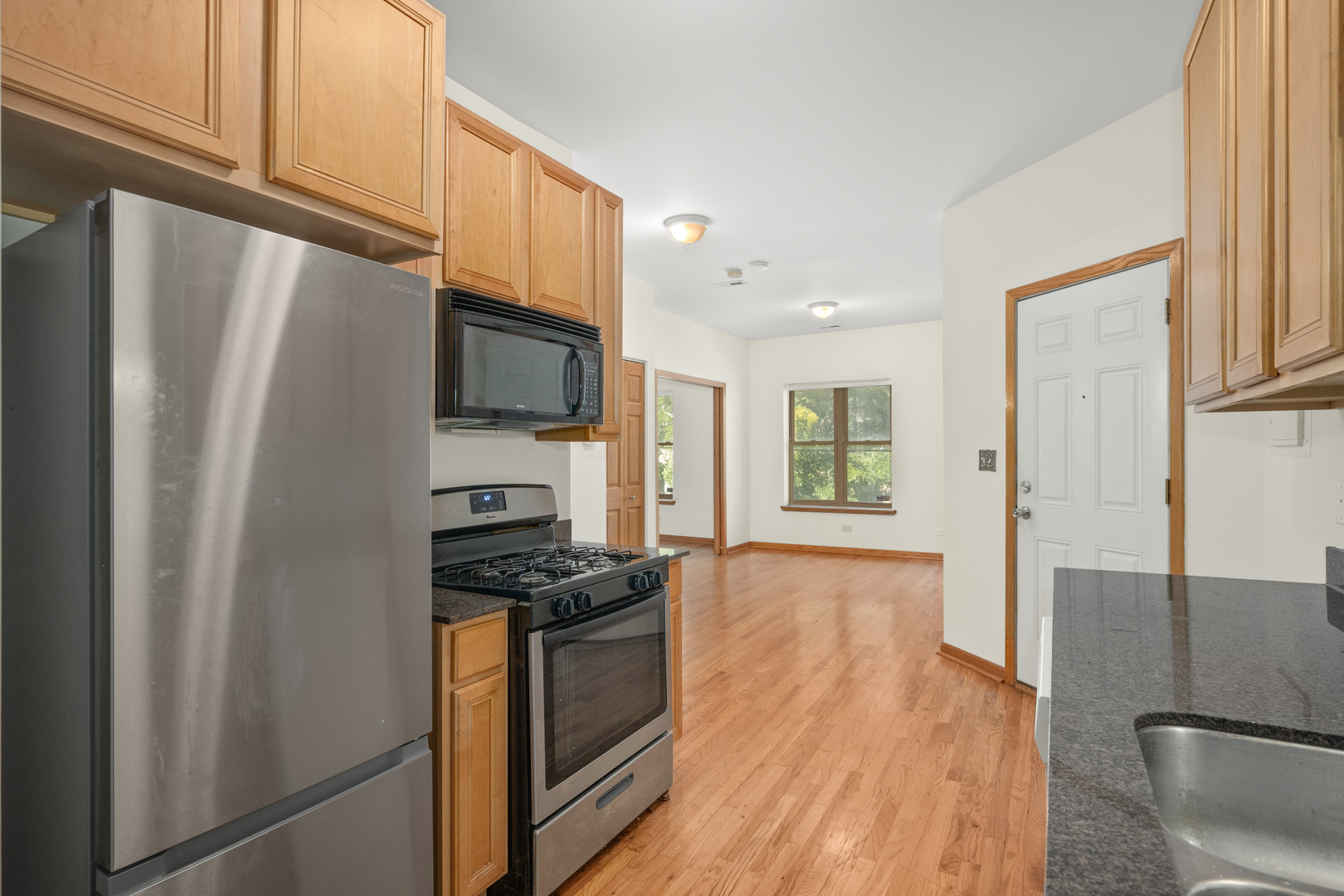 1167 East 61st Street, Unit 2 Chicago, IL 60637 - Photo 11 of 17 a kitchen with stainless steel appliances a refrigerator and a stove top oven