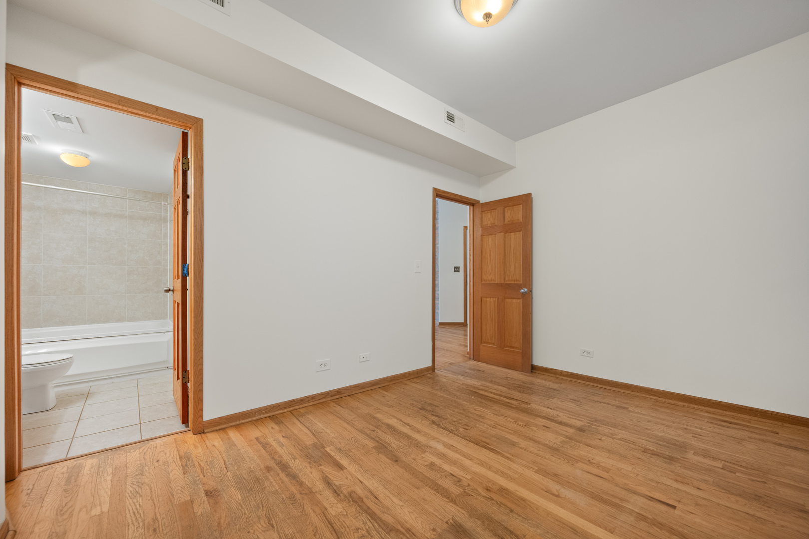 1167 East 61st Street, Unit 2 Chicago, IL 60637 - Photo 14 of 17 wooden floor in an empty room