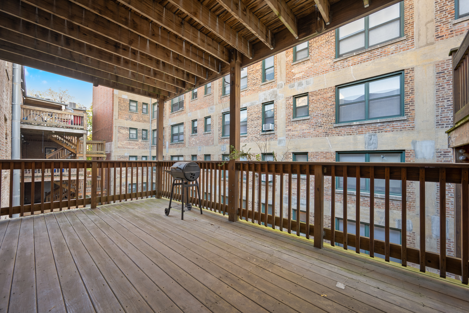 1167 East 61st Street, Unit 2 Chicago, IL 60637 - Photo 17 of 17 a view of a balcony with wooden floor