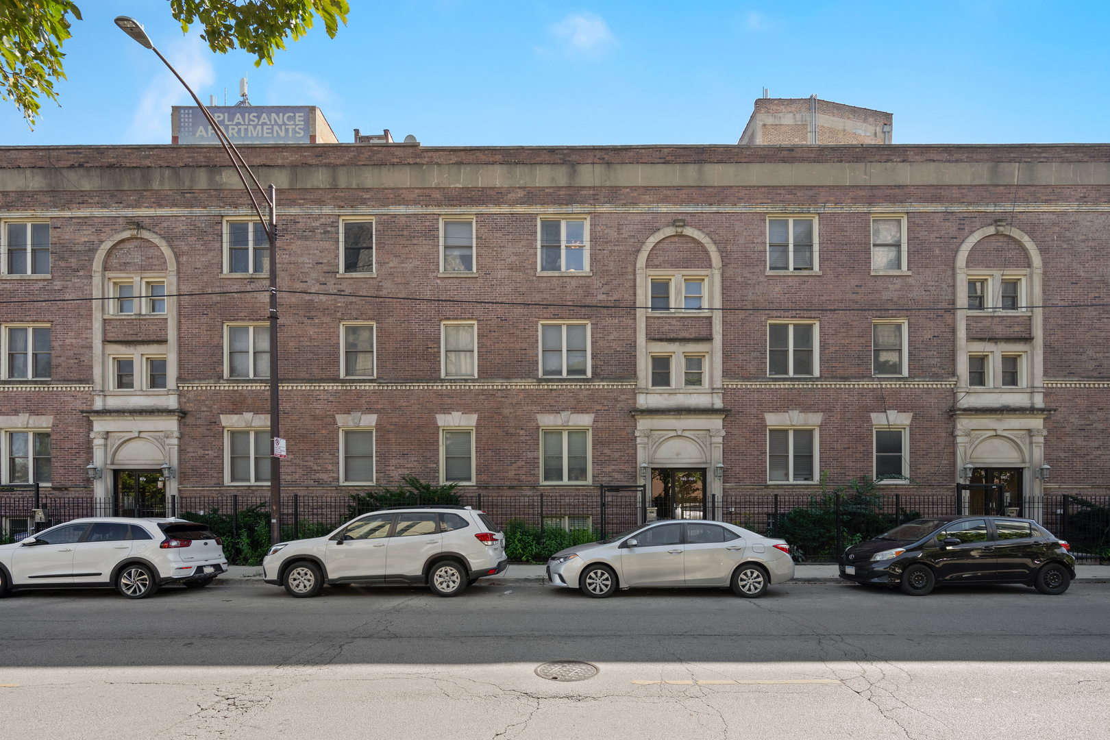 1167 East 61st Street, Unit 2 Chicago, IL 60637 - Photo 2 of 17 a view of a cars parked in front of a brick building
