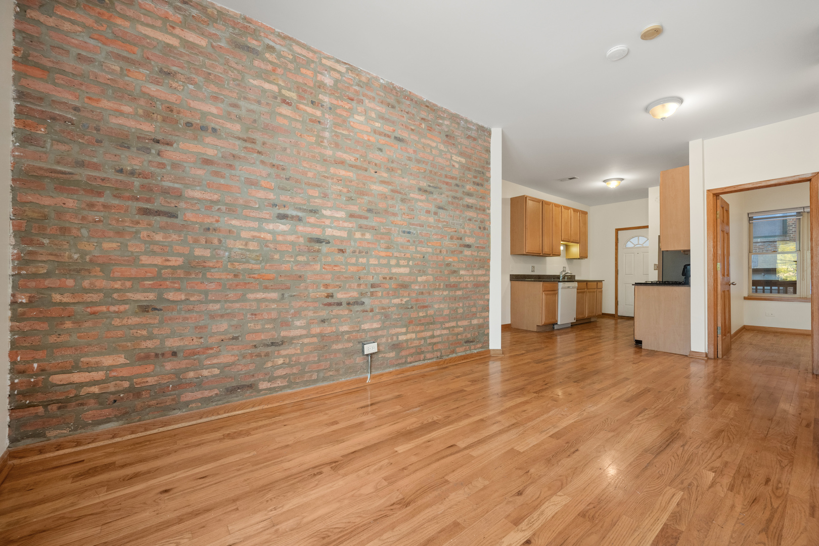 1167 East 61st Street, Unit 2 Chicago, IL 60637 - Photo 5 of 17 a view of a kitchen with wooden floor and a refrigerator