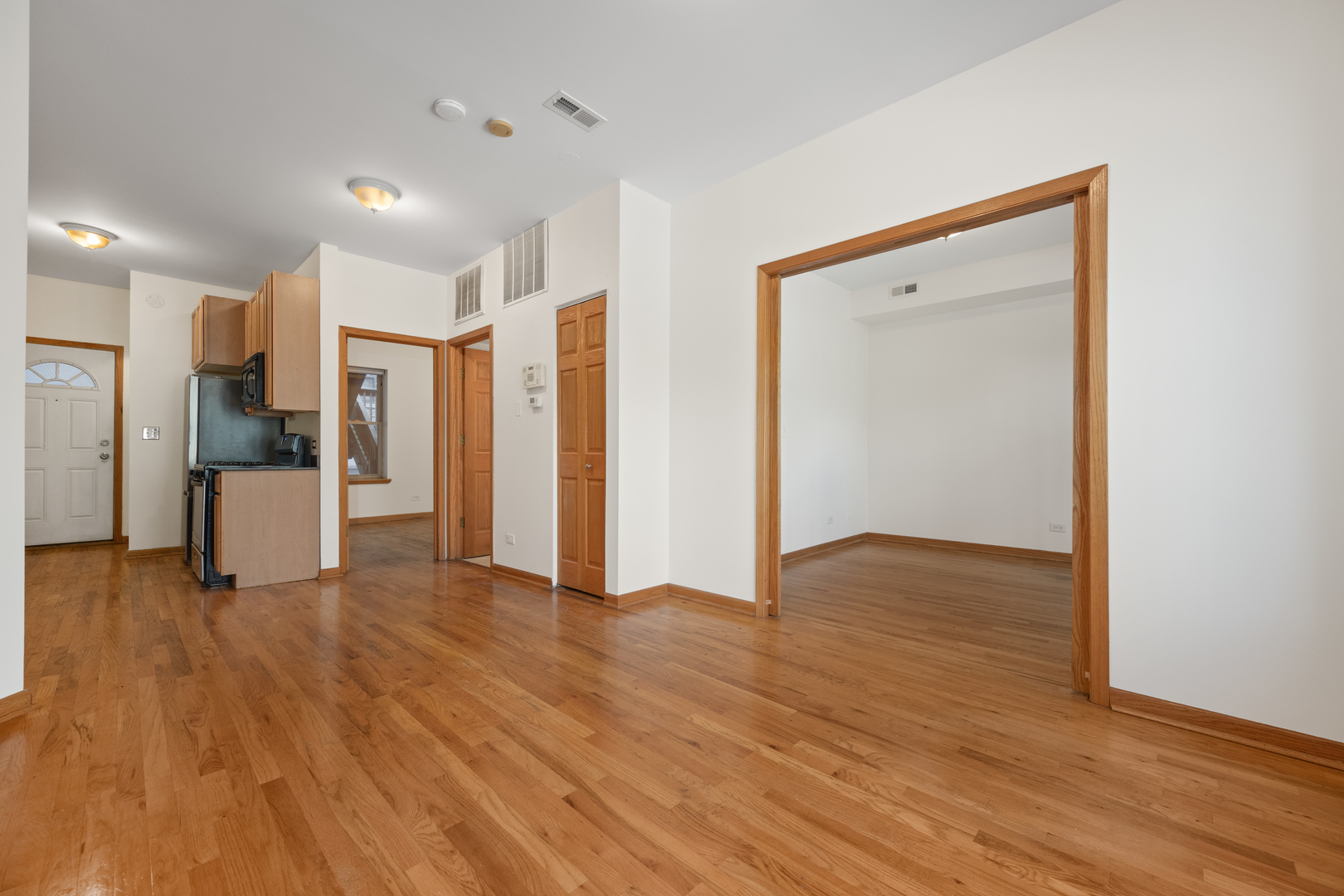 1167 East 61st Street, Unit 2 Chicago, IL 60637 - Photo 6 of 17 a view of empty room with wooden floor