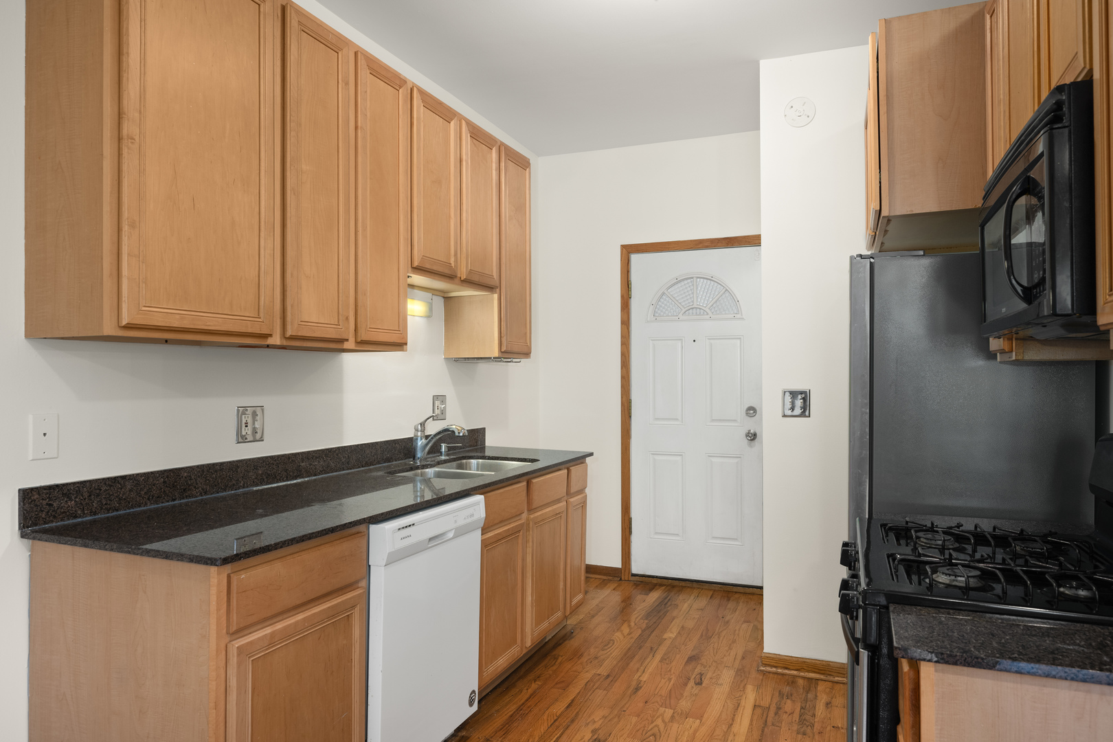 1167 East 61st Street, Unit 2 Chicago, IL 60637 - Photo 9 of 17 a kitchen with stainless steel appliances a stove a sink and a refrigerator