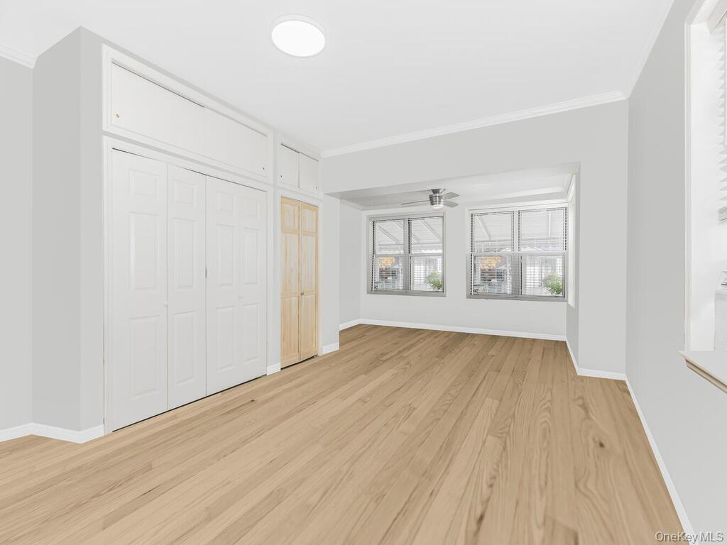 146-84 182nd Street Queens, NY 11413 - Photo 12 of 45 an empty room with wooden floor and windows