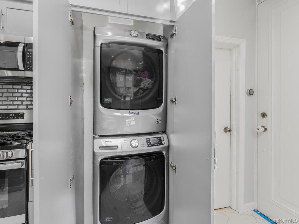 146-84 182nd Street Queens, NY 11413 - Photo 14 of 45 a utility room with dryer and washer
