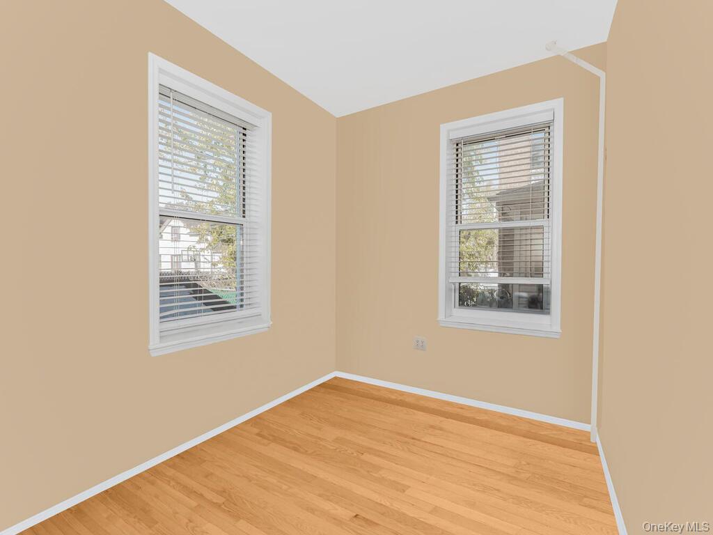 146-84 182nd Street Queens, NY 11413 - Photo 26 of 45 a view of an empty room with wooden floor and a window