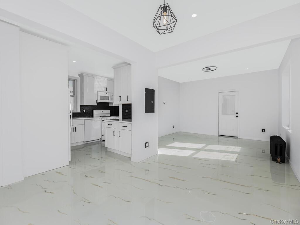 146-84 182nd Street Queens, NY 11413 - Photo 28 of 45 a view of kitchen with microwave and cabinets