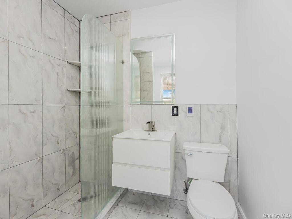 146-84 182nd Street Queens, NY 11413 - Photo 36 of 45 a bathroom with a sink toilet and shower