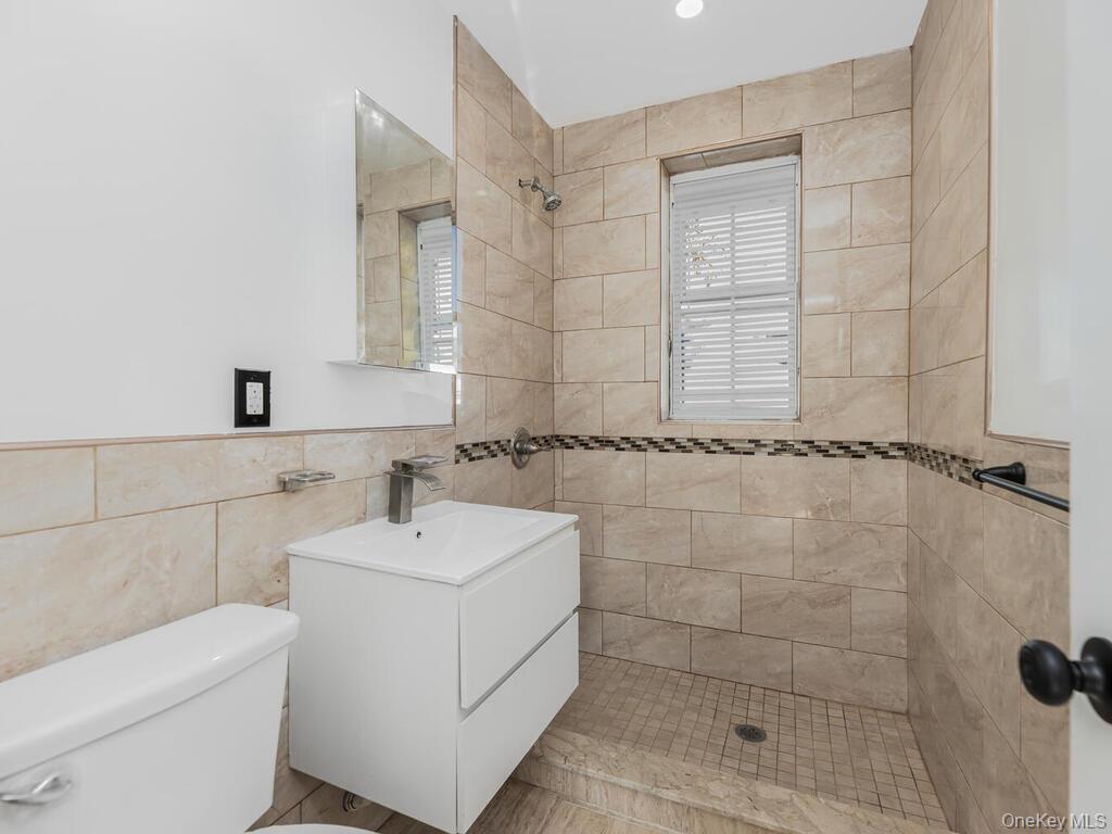 146-84 182nd Street Queens, NY 11413 - Photo 37 of 45 a bathroom with a sink a toilet and shower