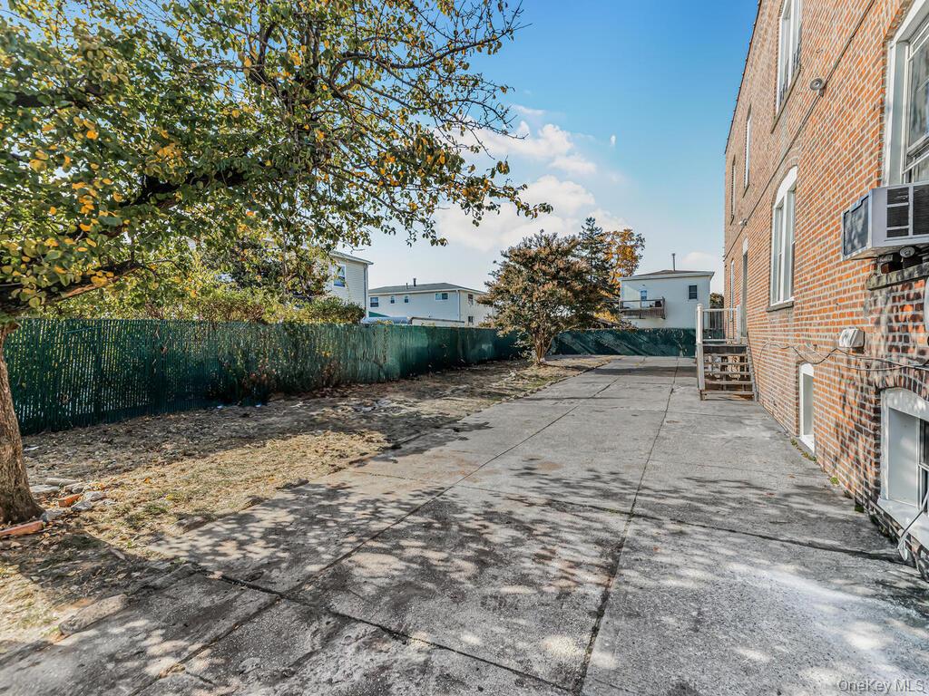 146-84 182nd Street Queens, NY 11413 - Photo 43 of 45 a view of a backyard with plants and wooden fence
