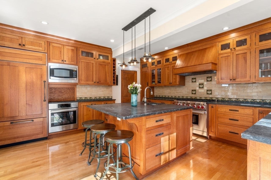 46 Hyslop Road Brookline, MA 02445 - Photo 12 of 33 a kitchen with stainless steel appliances granite countertop a stove top oven a sink and dishwasher