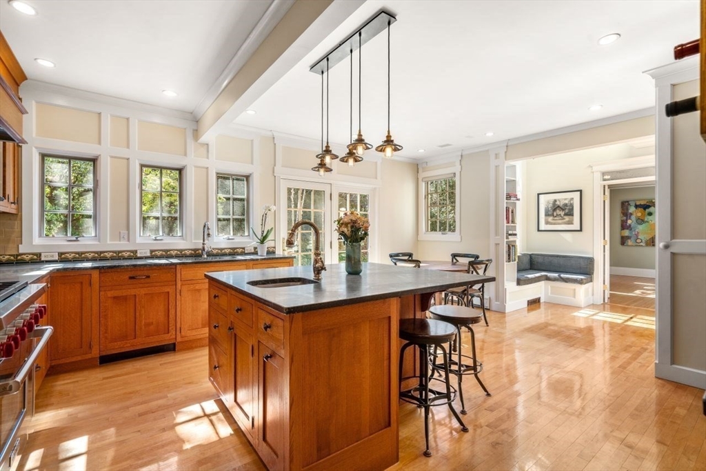 46 Hyslop Road Brookline, MA 02445 - Photo 13 of 33 a large kitchen with granite countertop a stove a sink a dining table and chairs
