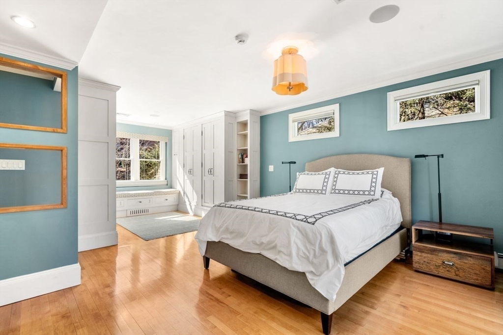 46 Hyslop Road Brookline, MA 02445 - Photo 18 of 33 a bedroom with a bed and wooden floor